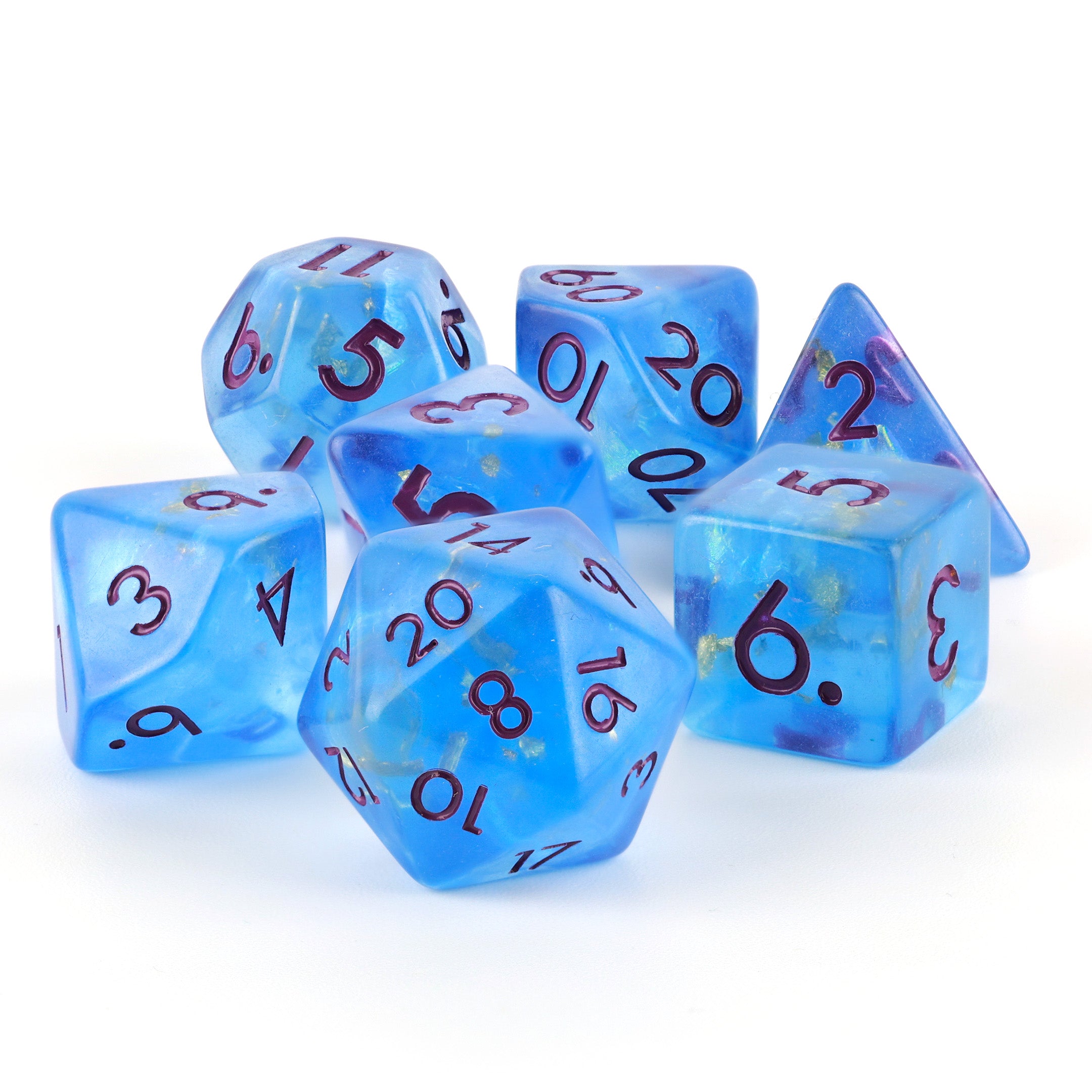Set of blue polyhedral dice with black numbers and gold leaf on a white background