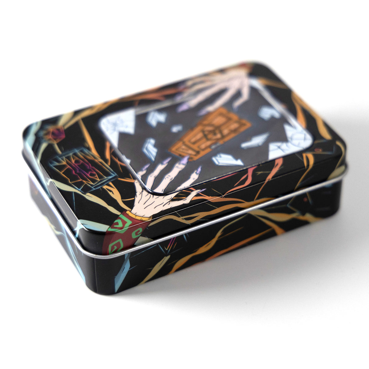 A rectangular metal tin with a glossy black background and an illustrated design featuring a skeletal hand, orange geometric shapes, and colorful abstract line art, photographed on a clean white background.